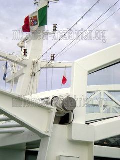 Gehisste Flagge vom Gastland bei der Einfahrt in den Hafen mit dem Kreuzfahrtschiff, zur Anlegestelle.